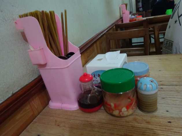 Tissues, chopsticks and spoons, jars of chilli paste and picked things and of course the toothpicks.